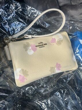 COACH Cream Pebbled Leather Floral Wristlet with Pink Accents